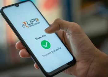 Person making a UPI payment on a smartphone while reviewing a transaction after accidentally sending extra money.