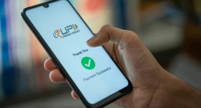 Person making a UPI payment on a smartphone while reviewing a transaction after accidentally sending extra money.